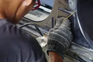 up close of auto tech welding