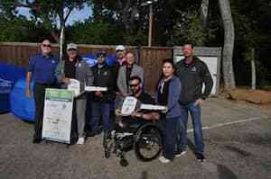 group of people together at a NABC vehicle donati