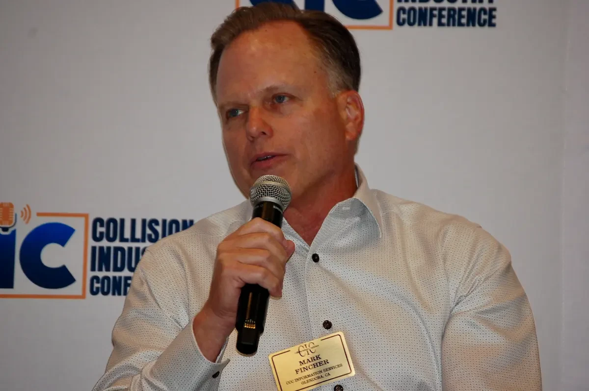 Mark Fincher of CCC Intelligent Solutions with a microphone