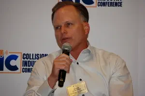 Mark Fincher of CCC Intelligent Solutions with a microphone