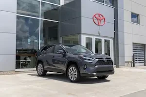 Toyota RAV4 in front of a dealership