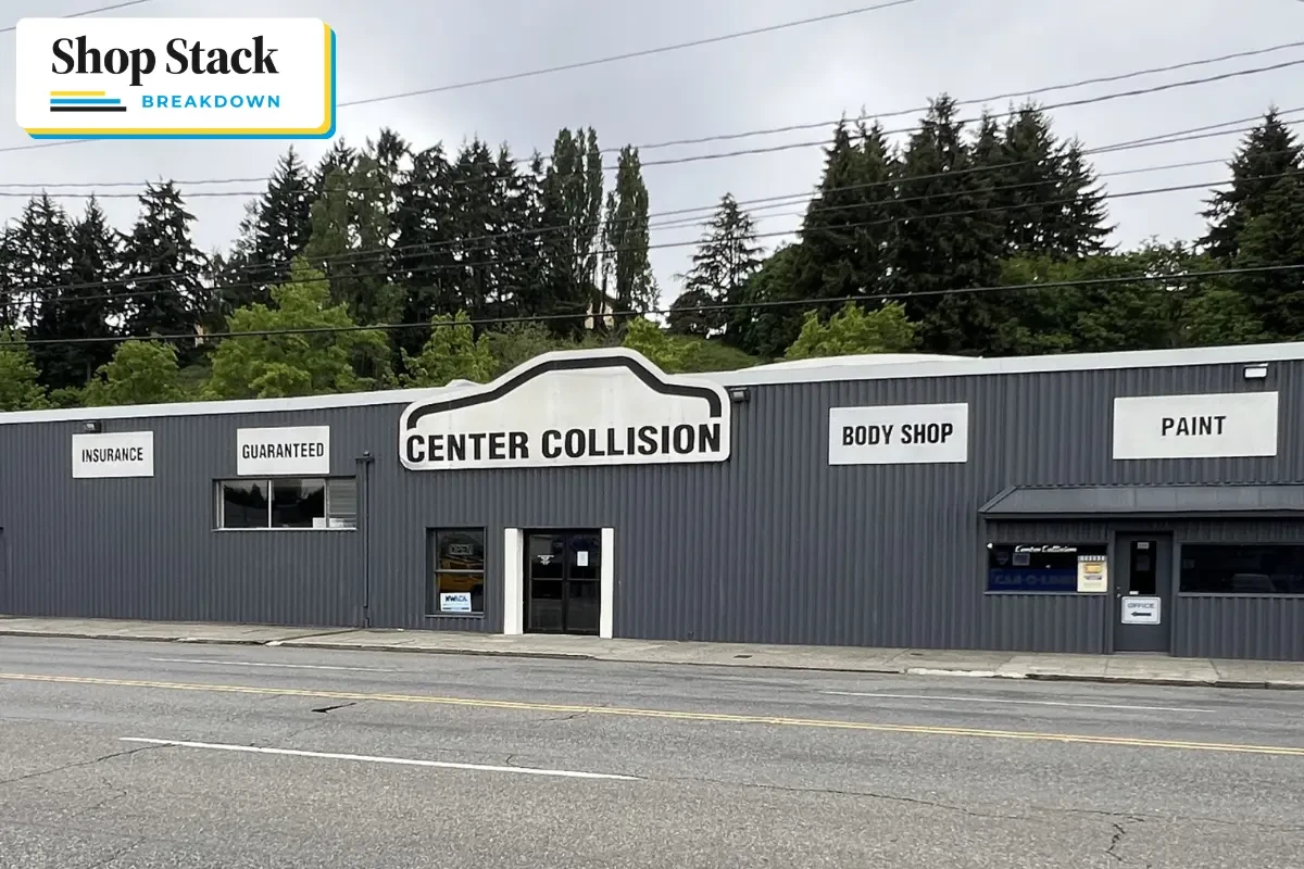 Gray building with white signage that says Center Collision in the middle, along with Insurance, Guaranteed, Body Shop, and Paint.