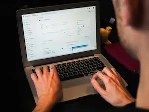 person typing on a laptop