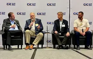 four men sitting on a panel