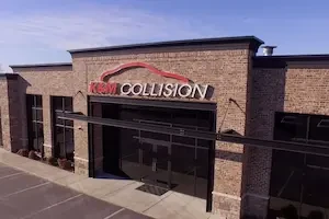 Exterior of brown brick building with lots of windows and a sign that says K&M Collision with the outline of a car above it