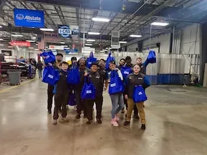 Sherwin-Williams employees holding blue bags