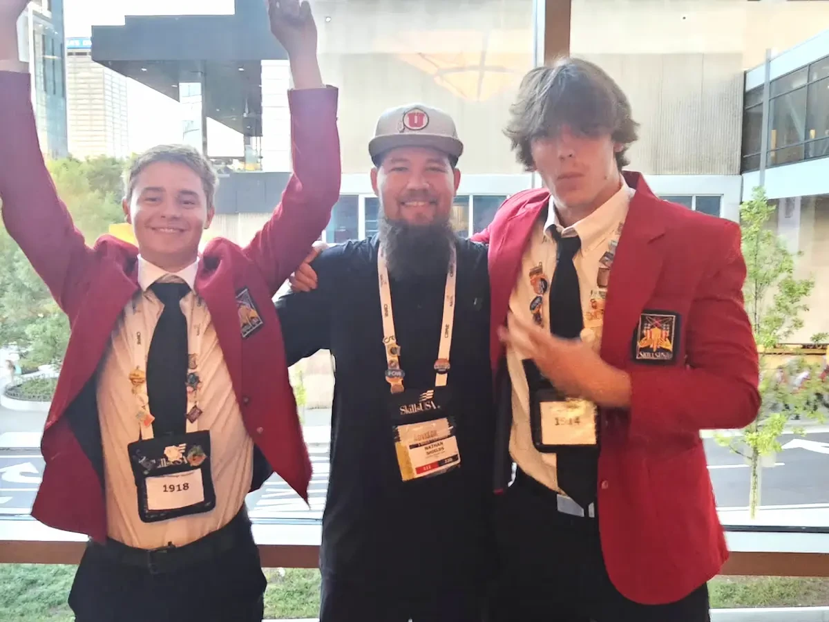 Nathan Shields posing with students