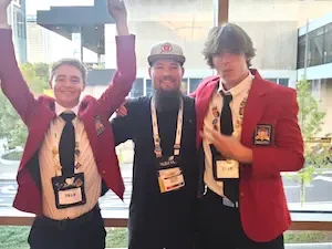 Nathan Shields posing with students