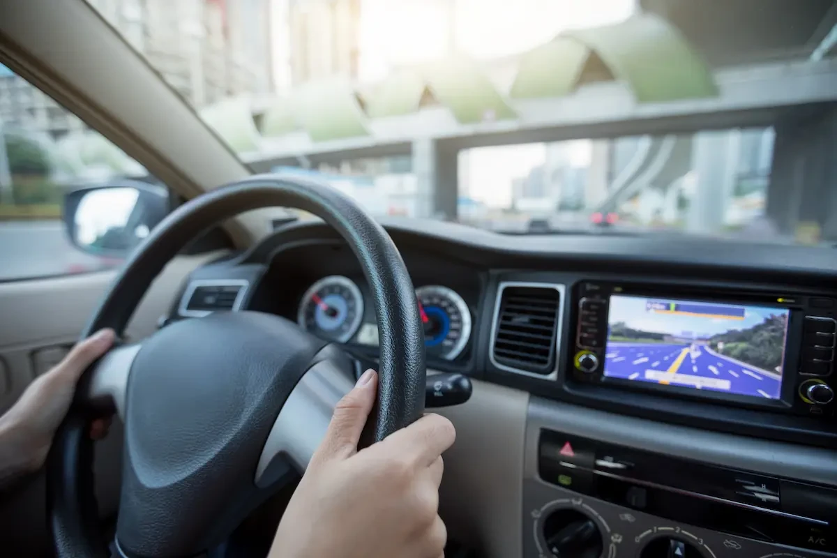 closeup of steering wheel with person driving