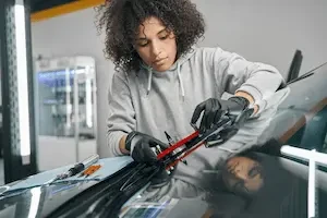 technician working on a windshield
