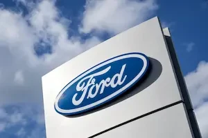 Ford logo on a sign with a blue sky background