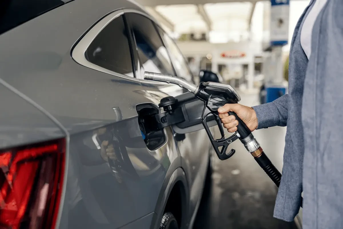person filling a car up with gas