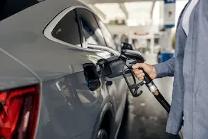 person filling a car up with gas