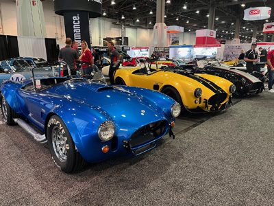A lineup of replica Shelby Cobras at the Superformance booth.