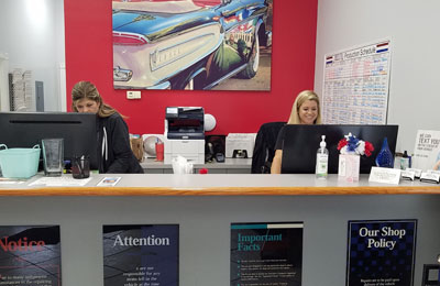 two-women-sitting-at-front-desk