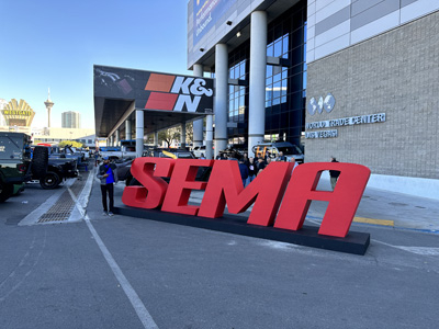 Attendees pose with a SEMA sign outside the South Hall.