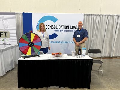 Laura Gay, left, and Chad Smith, right, at the Consolidation Coach booth.