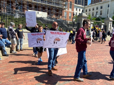 A vocal group of more than 60 people gathered outside the Massachusetts State House to demand action on two proposed bills currently before lawmakers.