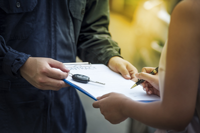 technician-giving-driver-rental-car-key