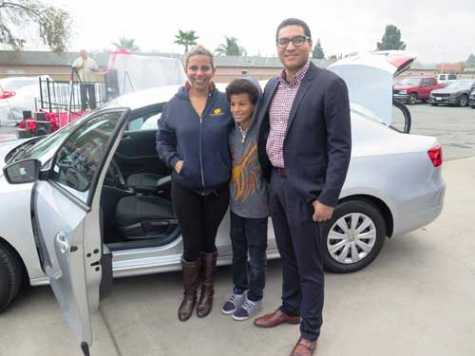 Veteran TeJae Dunnivant and her son received a 2014 VW Jetta from CSAA Insurance. CSAA Insurance Group's Community Affairs Coordinator Victor Cordon stands with the Dunnivants at Mike's Auto Body.