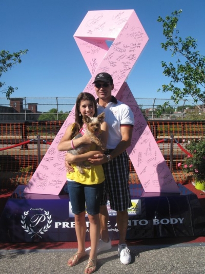 Dave Ludwig and his daughter, Elizabeth, stand next to Ludwig&#039;s first sculpture, a 9-foot pink ribbon that he designed with a local radio station to create awareness about breast cancer in New Hampshire. 