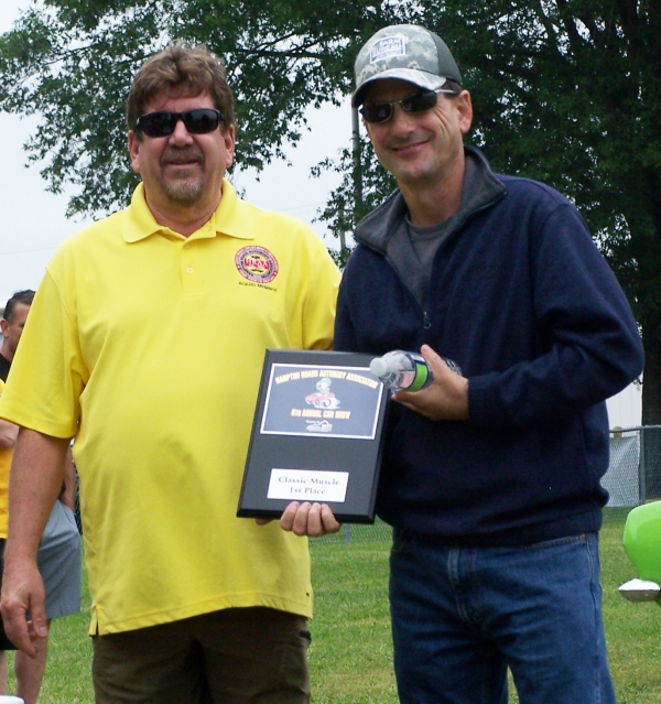 (Left) Steve Jellerson, President of Hampton Roads Autobody Association (HRAA), (Right) Bernard Chicoine, winner in the Classic Muscle Car category at the HRAA Car Show in Chesapeake, VA for his lime green 1967 Plymouth Barracuda .
