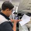 Mission Viejo Auto Collision technician Luis Cisneros reviews print out and confirms and documents weld count and location. Management then reviews and confirms communication and documentation from a mobile device or PC.