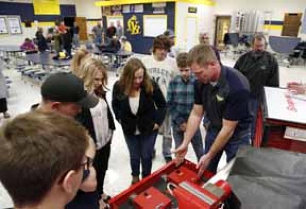 North Butler Middle/High School industrial tech teacher Dave Brown, right, shows the visitors some of the Snap-On tools used in the new precision measuring instruments program. 