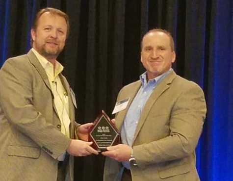 Brian Nessen presents John Spoto with the Service Provider of the Year award.