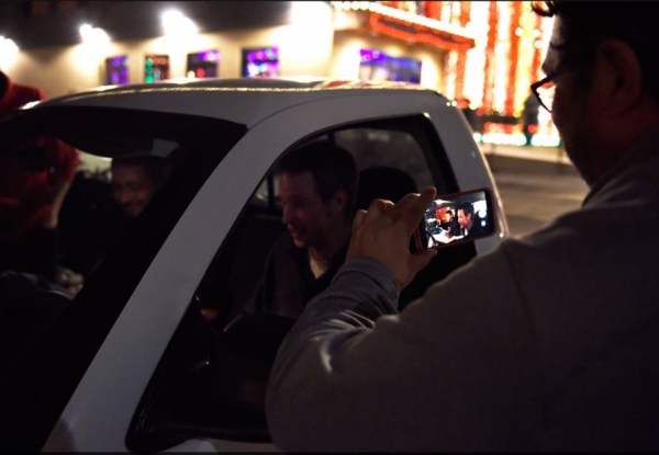 Chris Shell, right, takes a video of Michael Richard Crotchett, center, and Daniel Himes as they sit in Crotchett&#039;s new car for the first time at Logboat Brewing Company in Columbia, MO, on Dec. 21. Crotchett&#039;s previous car had broken down a few months ago. 