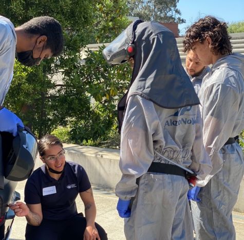 Laura Lozano, Contra Costa College professor of collision repair technology and co-chair of the automotive department, with high school students at the schools&#039; first Auto Tech Summer Camp. 