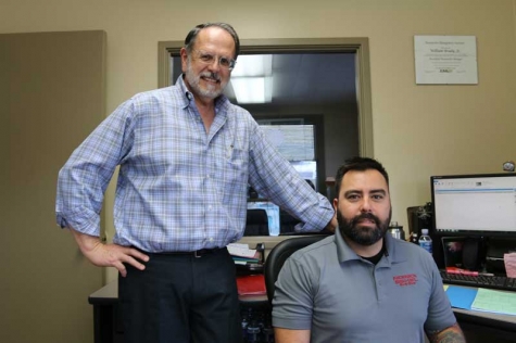 David Mello, left, is retiring and has sold his auto body shop to Crash Champions, but by mentoring people like Sales Manager Bill Brady, right, he knows his crew is well-trained and prepared for the next chapter.