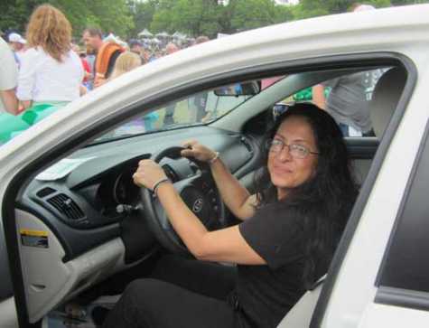 Diana Cuesta behind the wheel of her new NABC Recycled Rides™ car in 2014, presented by Caliber Collision and Farmers. 