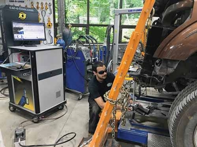 Andrew Smith at Opeka Auto Repair uses the Car-O-Tronic Vision to measure a Ford F-250 with the shop’s Car-O-Liner frame machine.