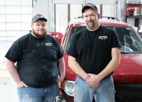 Jeffrey and Mike Middlebrook stand in their new body shop. 