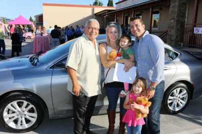 The gift of transportation, donated by Mike&#039;s Auto Body, helped Cassidy Nolan and his family grow and pursue their goals.  From left: Sal Contreras from Mike&#039;s Auto Body, Jillian Nolan, Cassidy Nolan and their two children. 