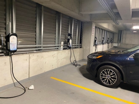 This brand new parking structure has six Level 2 240v EV chargers but no outside signs to help drivers find them.